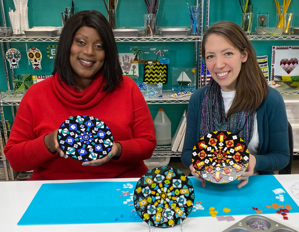 Tamani and Angela show off their pre-fired projects.